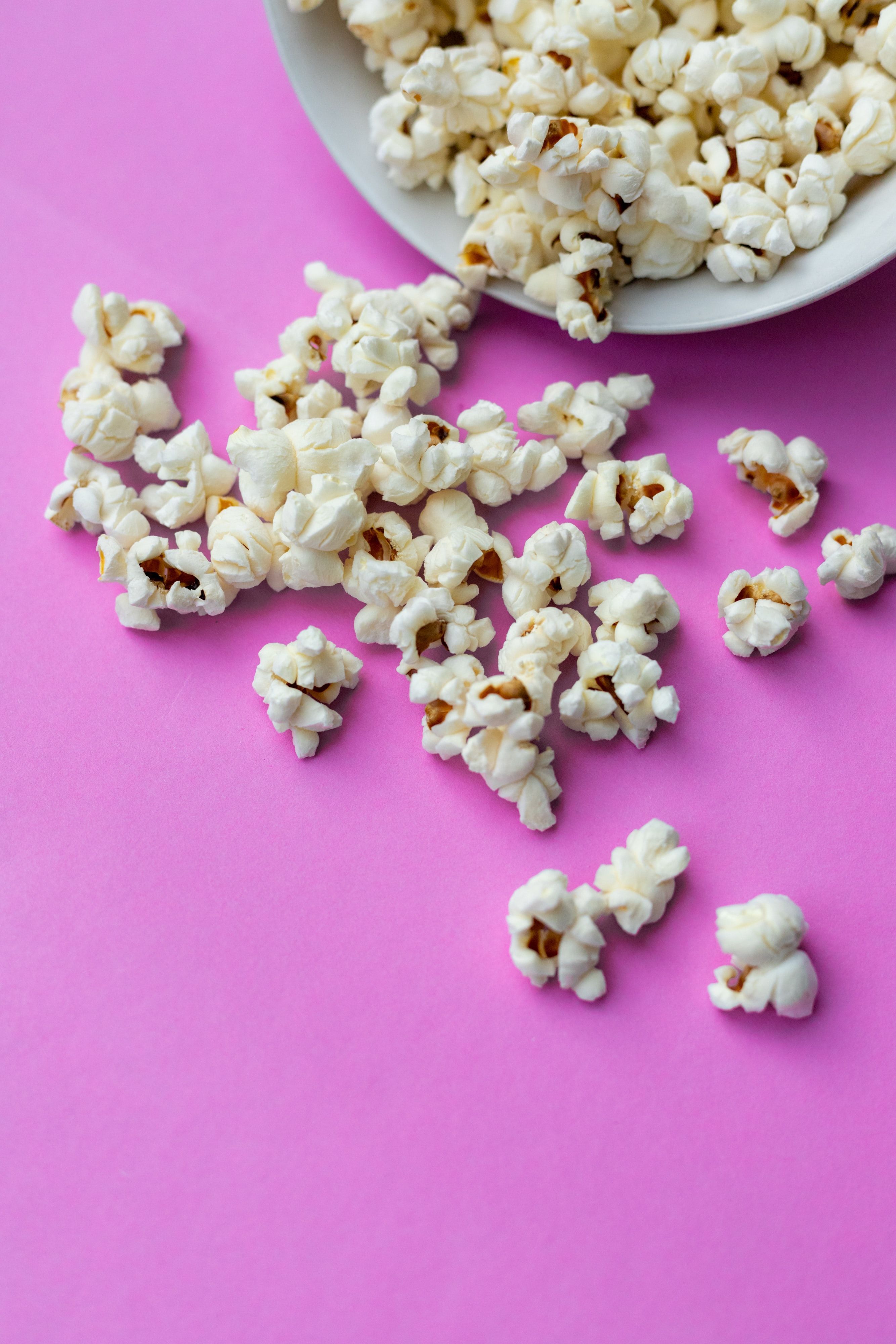 A bowl of popcorn on a pink background - Popcorn