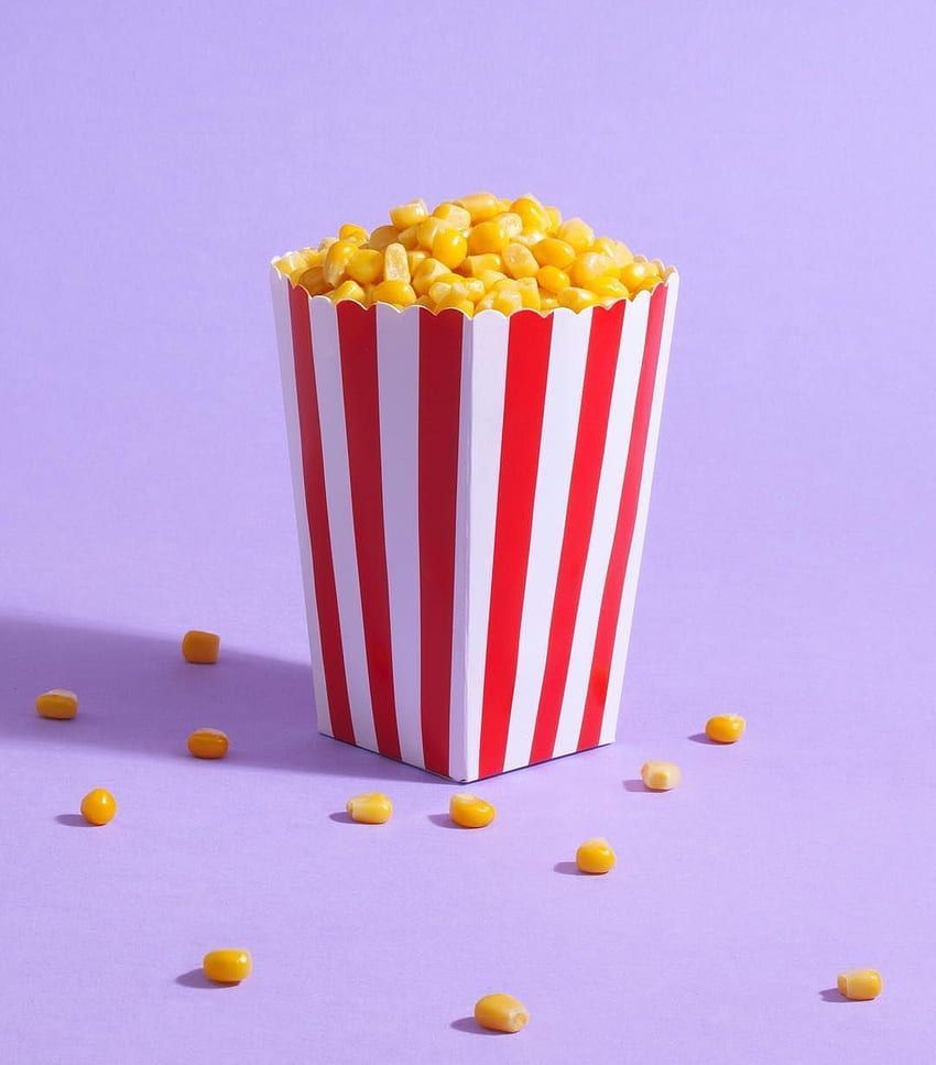 A popcorn box with yellow and white kernels - Popcorn