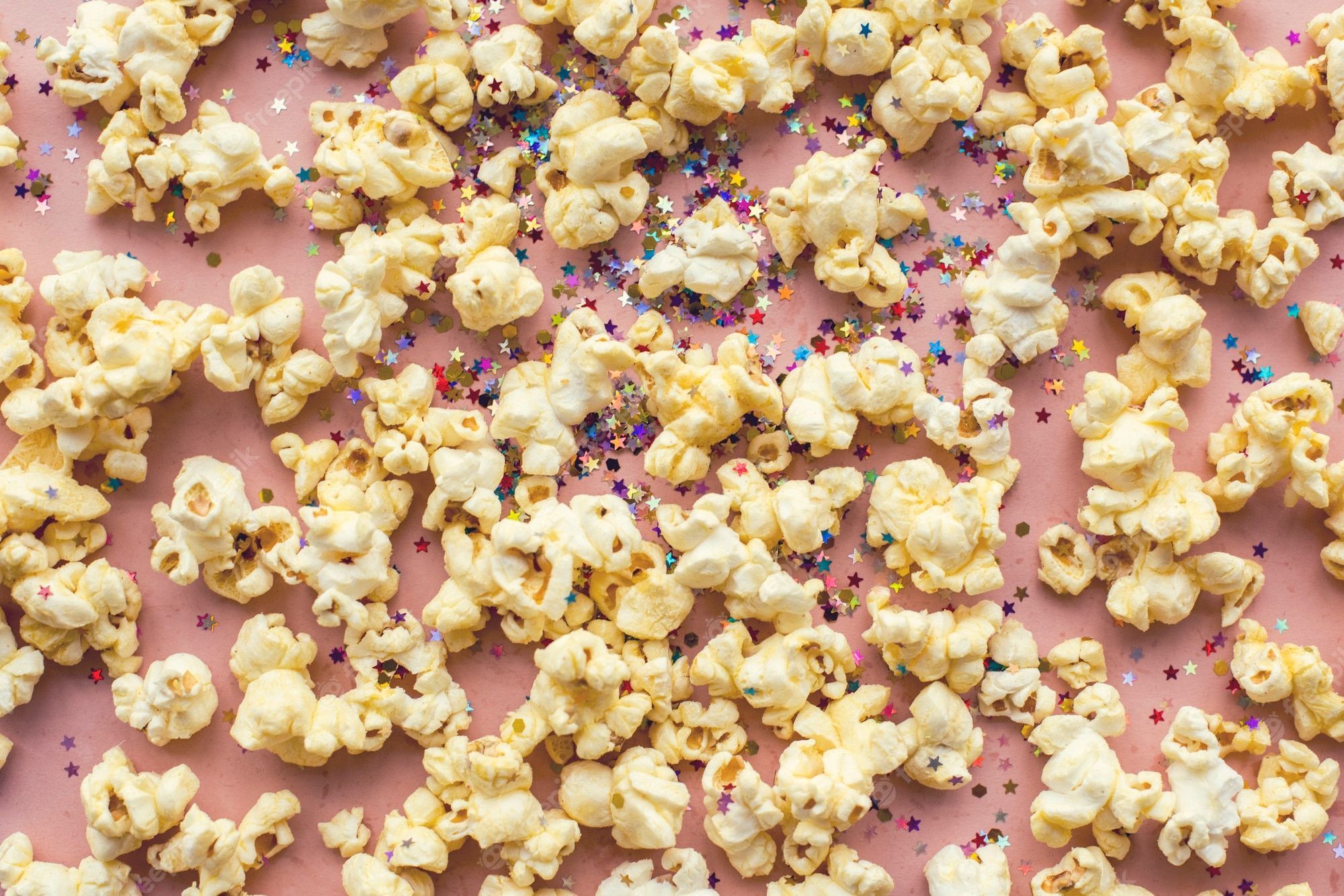 Popcorn and confetti on a pink background - Popcorn