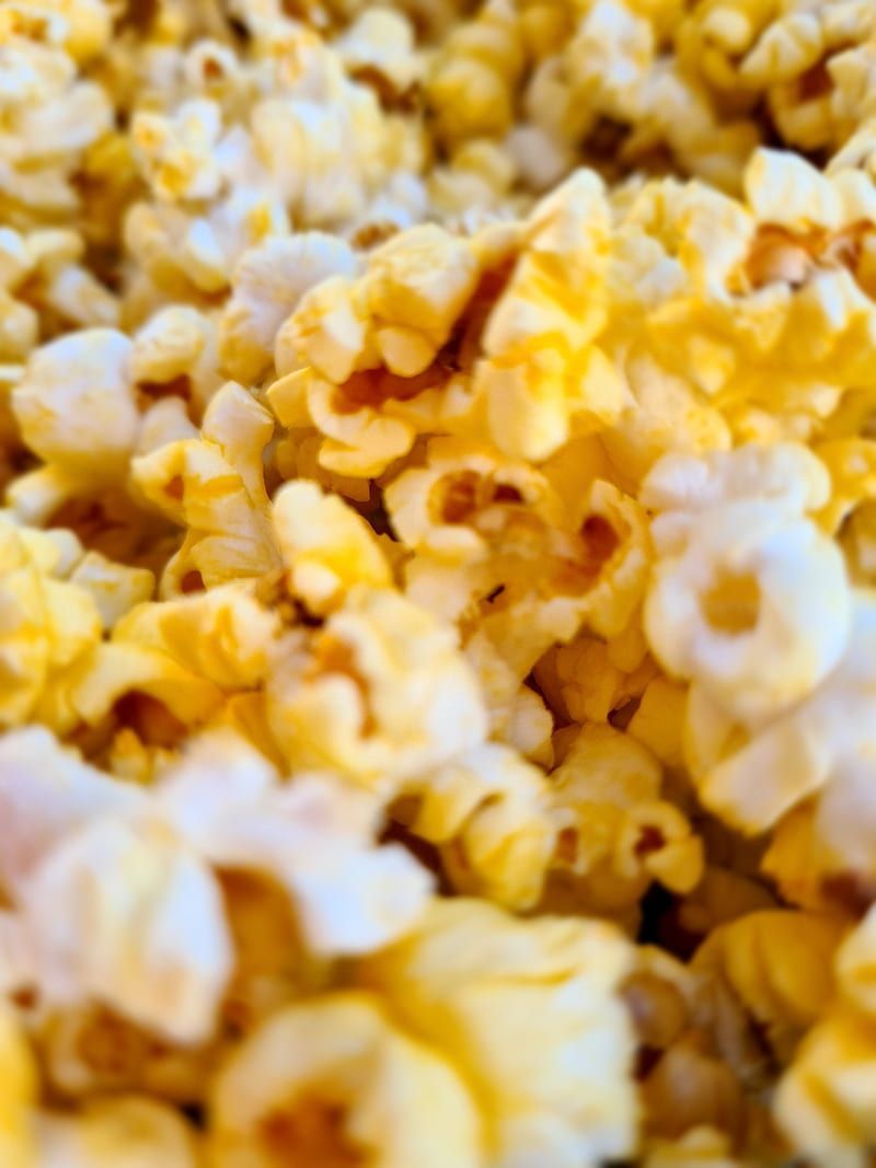 A close up of a pile of popcorn. - Popcorn