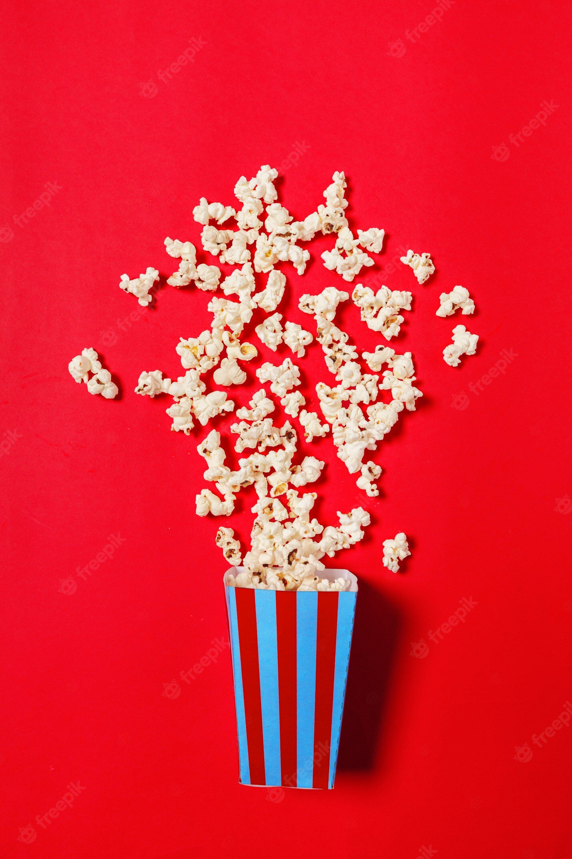 Popcorn in a blue box on red background - Popcorn