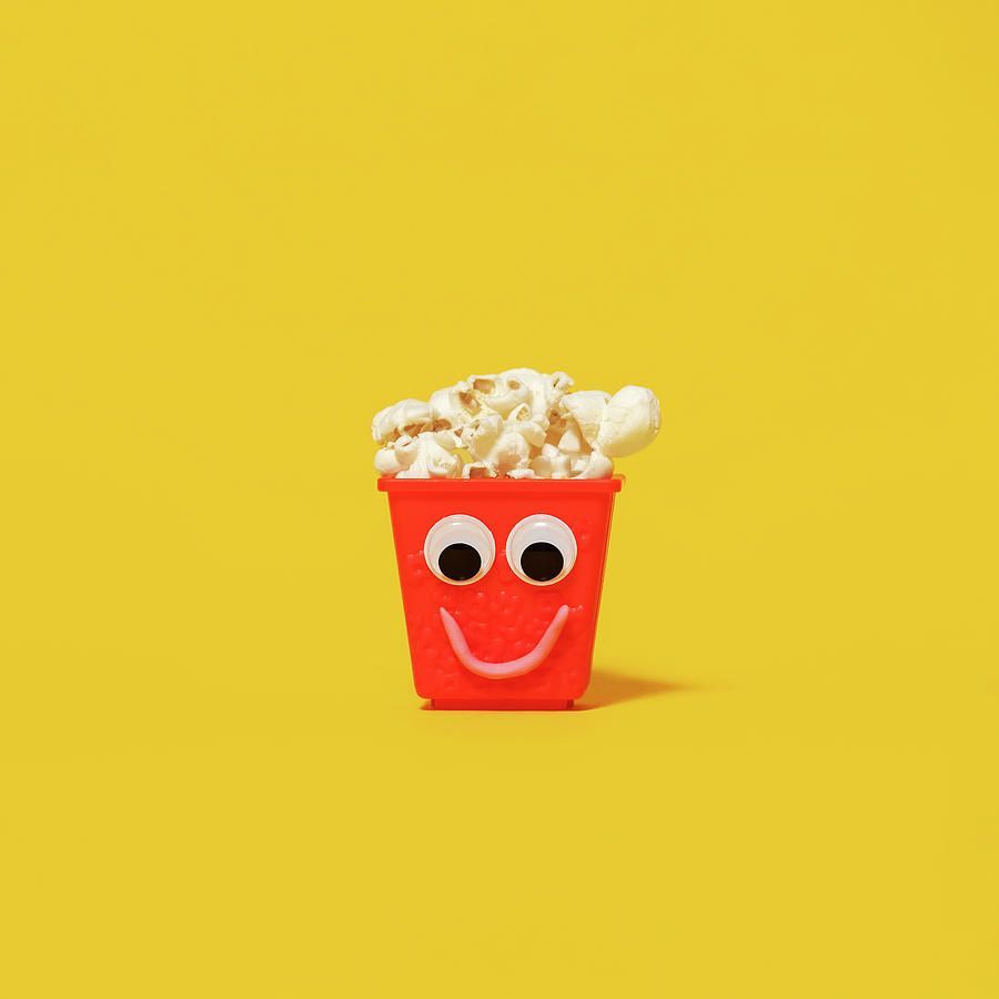 A small cup of popcorn with two eyes and mouth - Popcorn