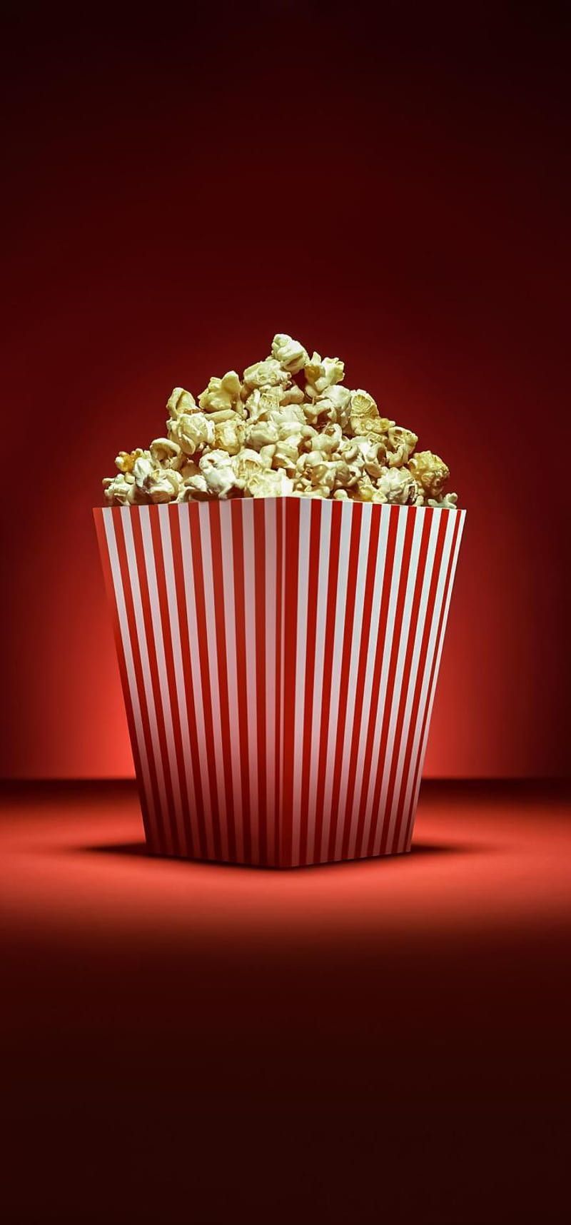 A bucket of popcorn on a red background - Popcorn