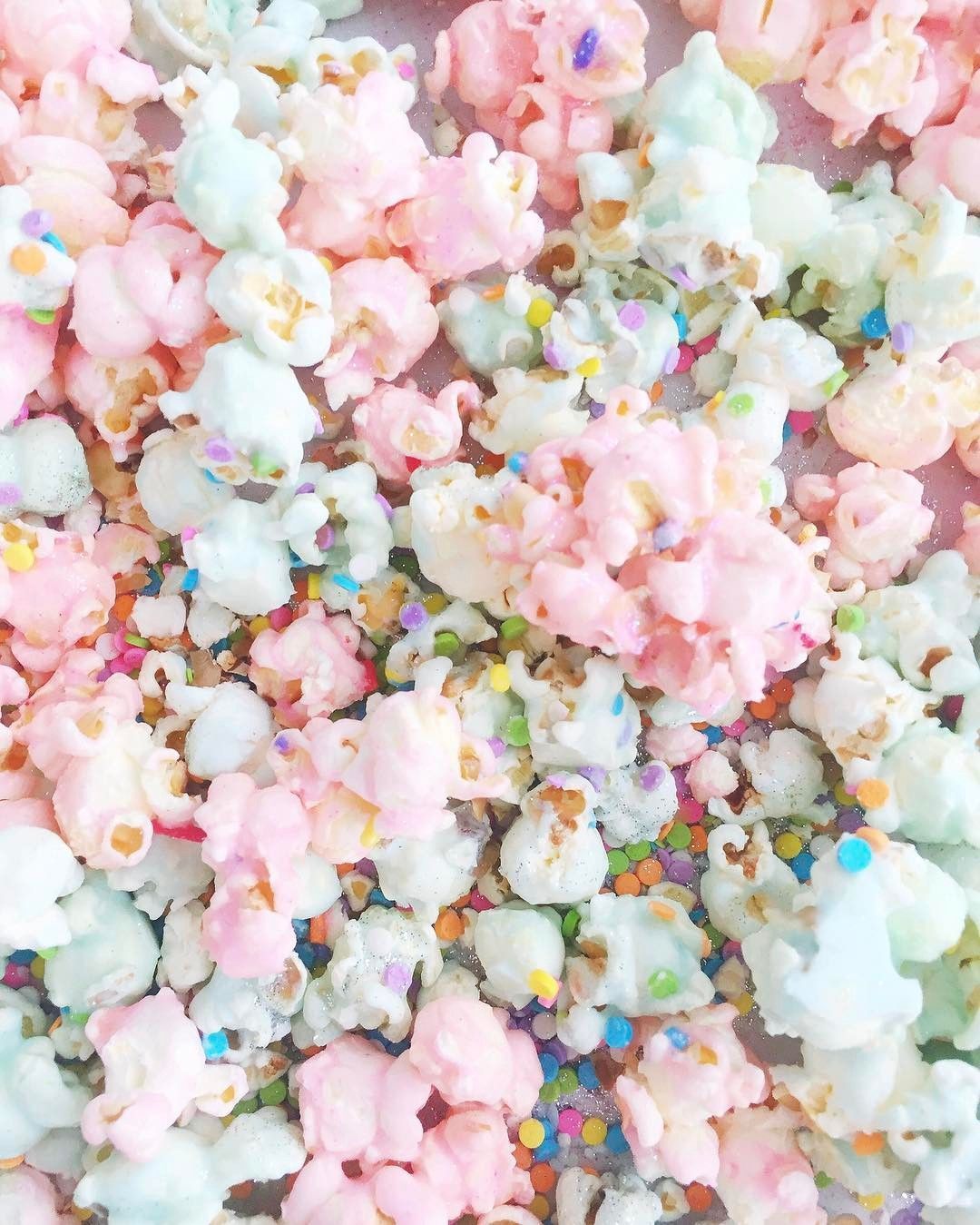 A close up of popcorn with sprinkles and candy - Popcorn