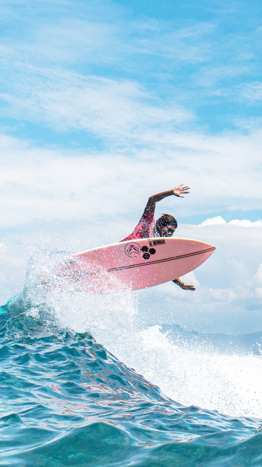 A surfer in a pink surfboard catching a wave - Surf