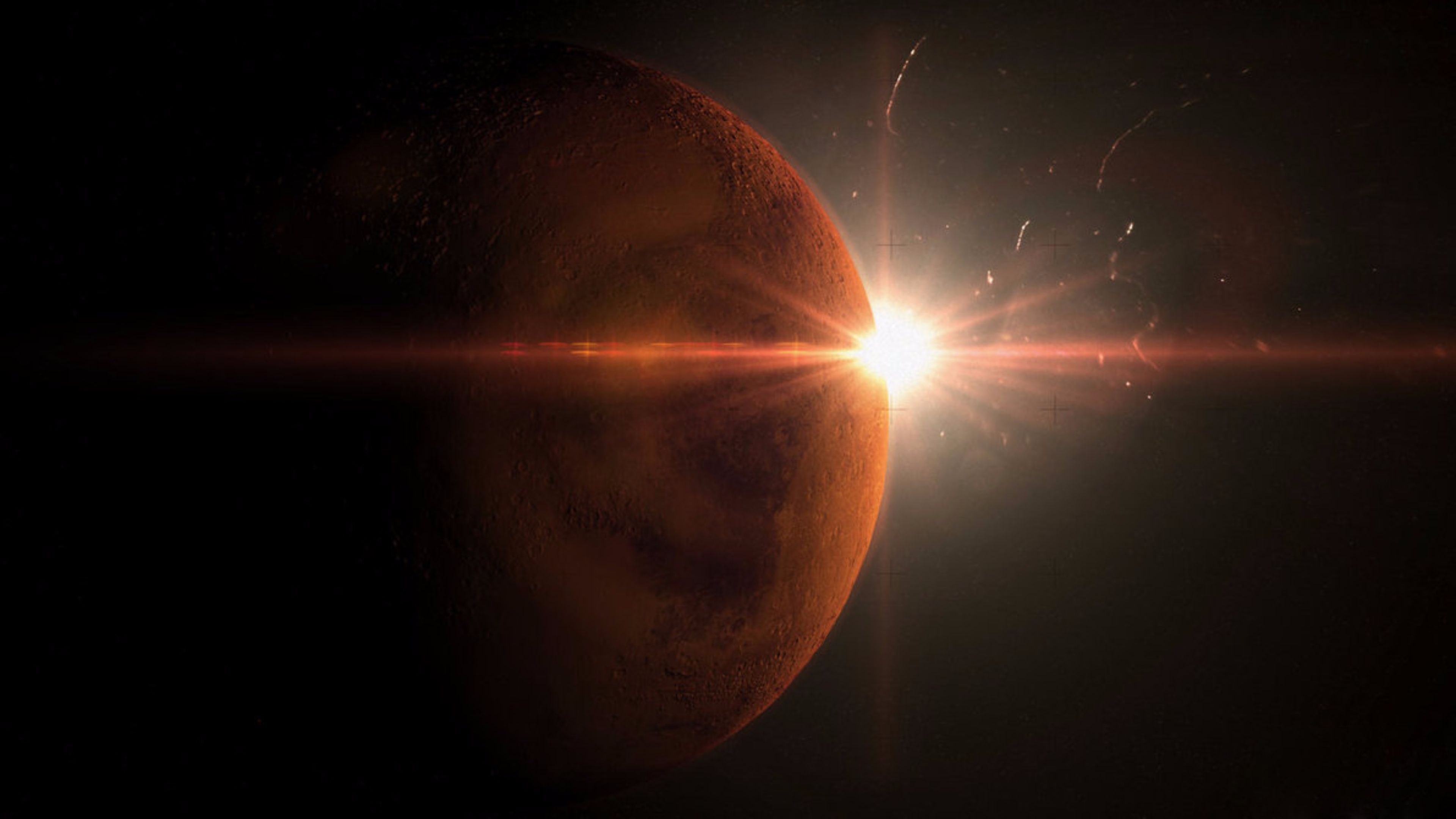 A planet with a sun behind it - Mars