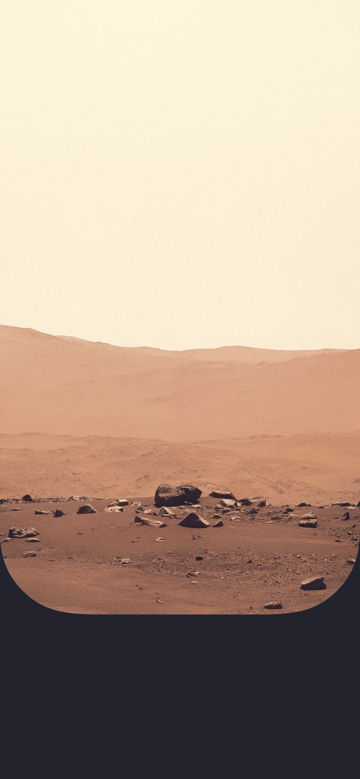 A sandy desert with a rock in the middle. - Mars