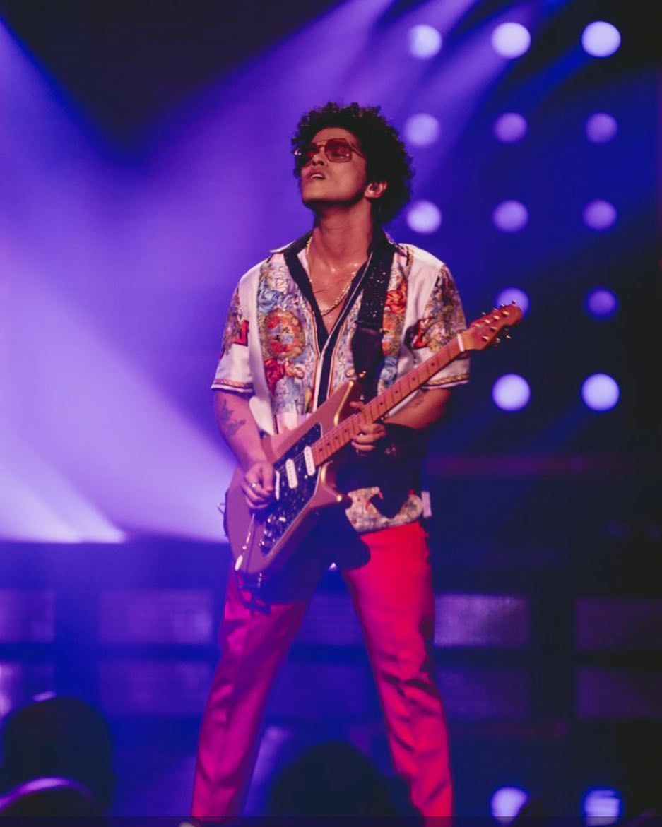 Bruno Mars is seen performing in a concert. - Bruno Mars