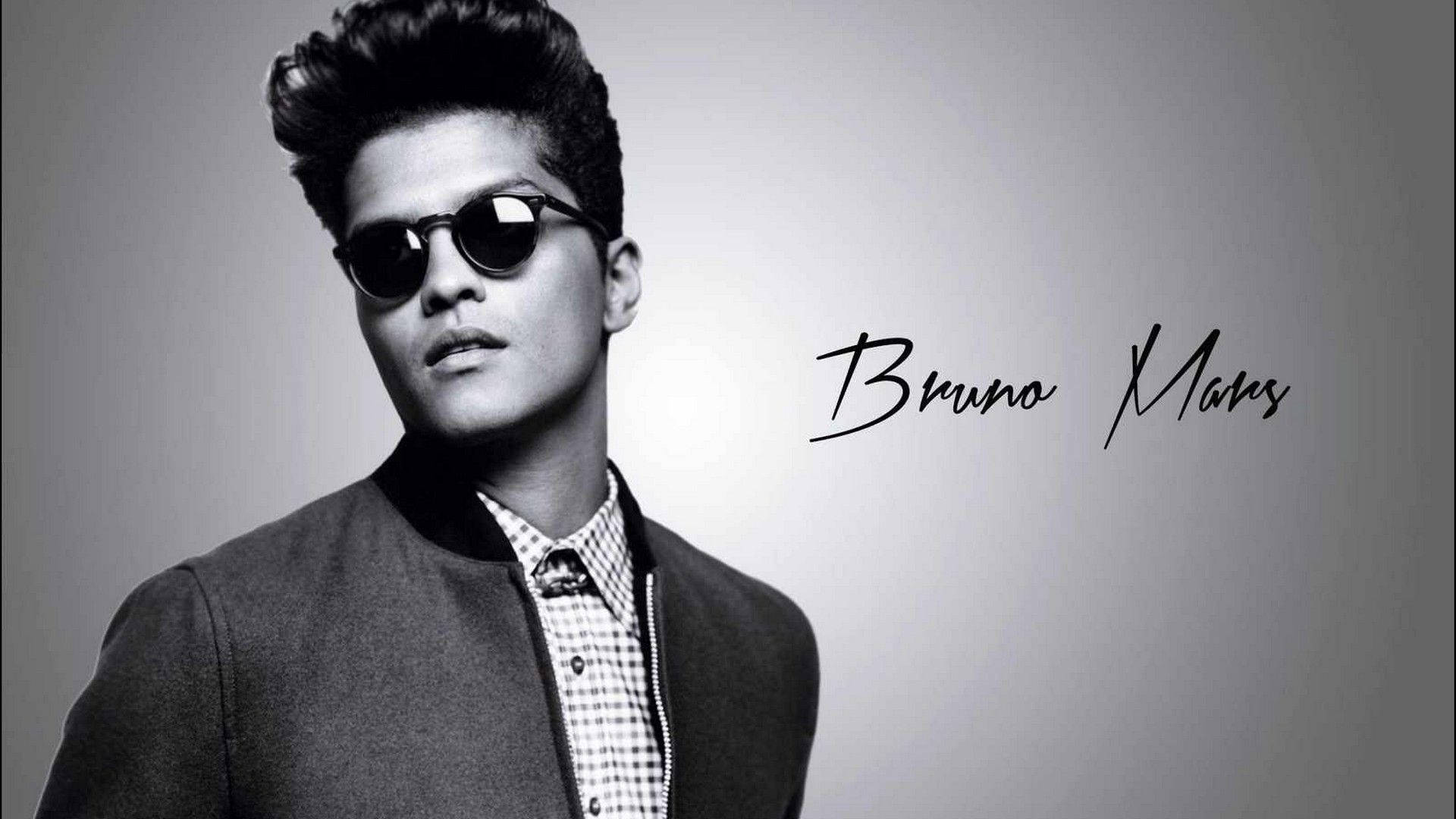 A man wearing sunglasses and jacket - Bruno Mars