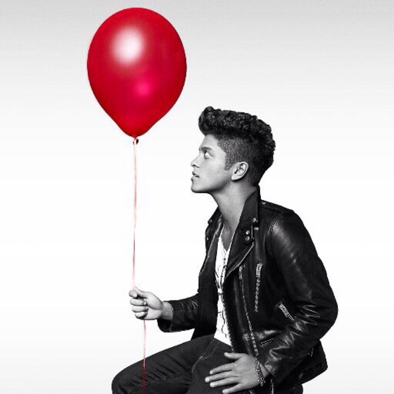 Bruno Mars holding a red balloon in a promotional photo for his album, Unorthodox Jukebox. - Bruno Mars