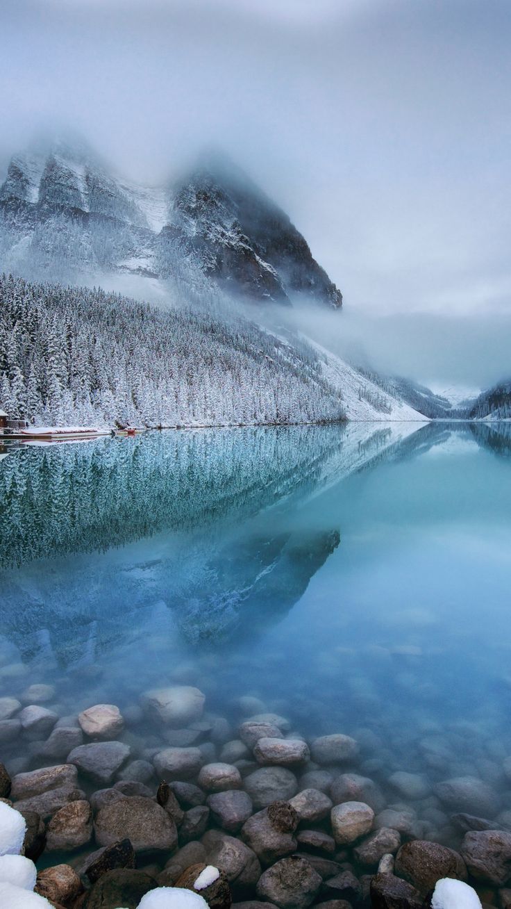 A mountain covered in snow is reflected in a lake - Lake