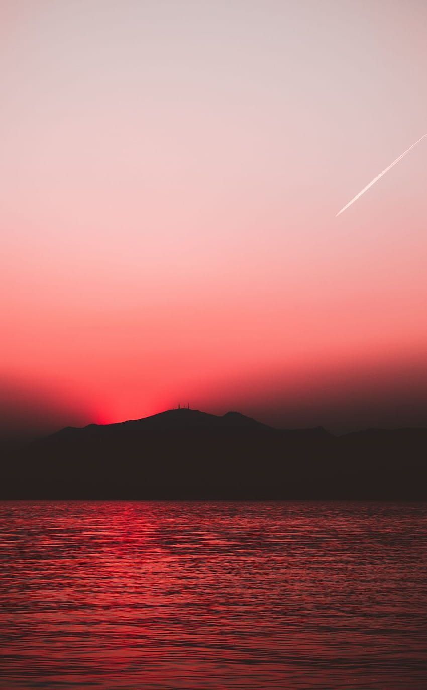 A red sky at sunset over a body of water - Lake