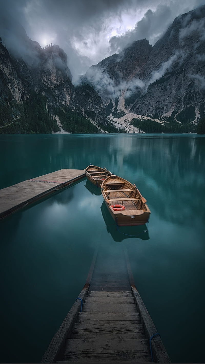 A boat tied to a dock in a lake - Lake