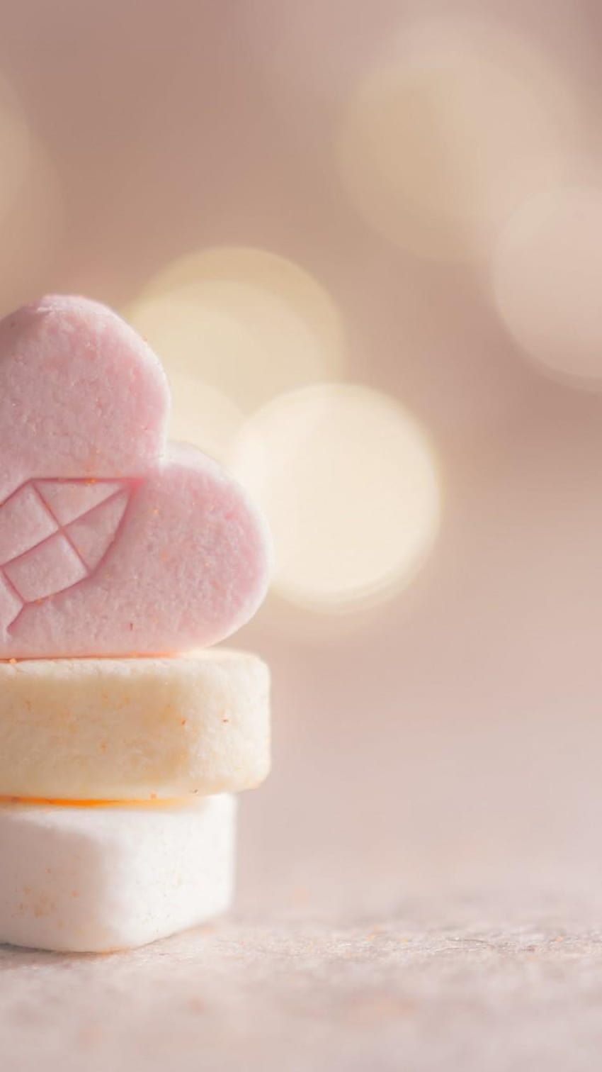 A pile of heart-shaped candy on a table - Marshmallows