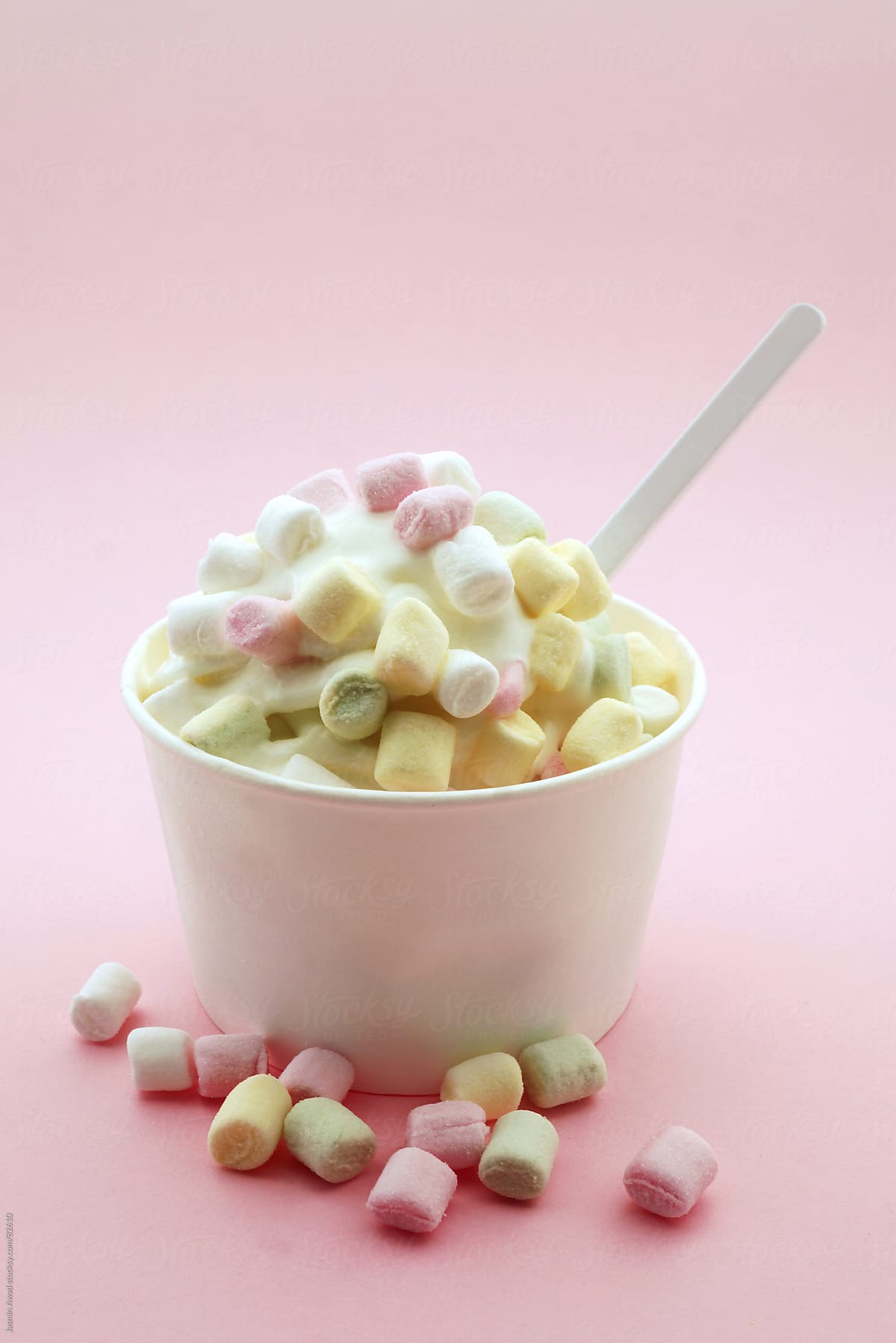 A bowl of ice cream with marshmallows on a pink background - Marshmallows