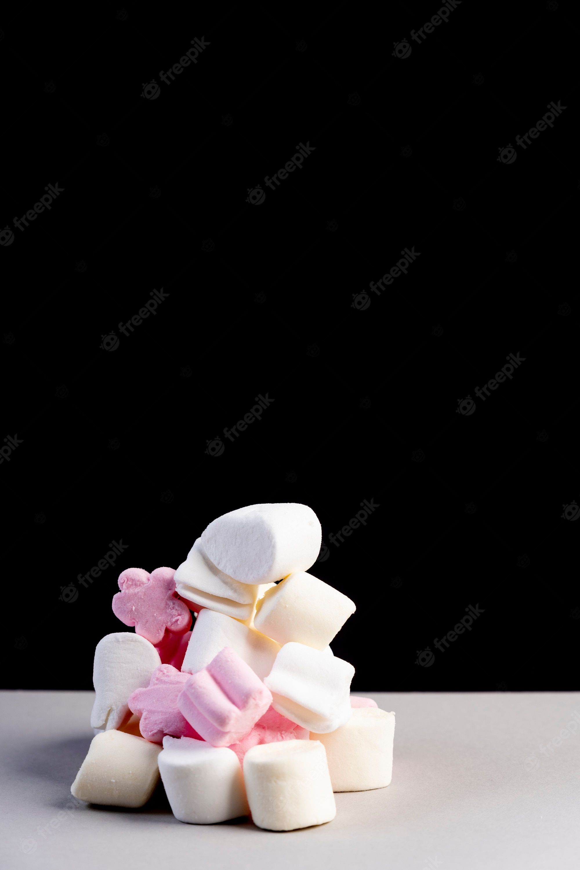 A tower of marshmallows on a black background - Marshmallows
