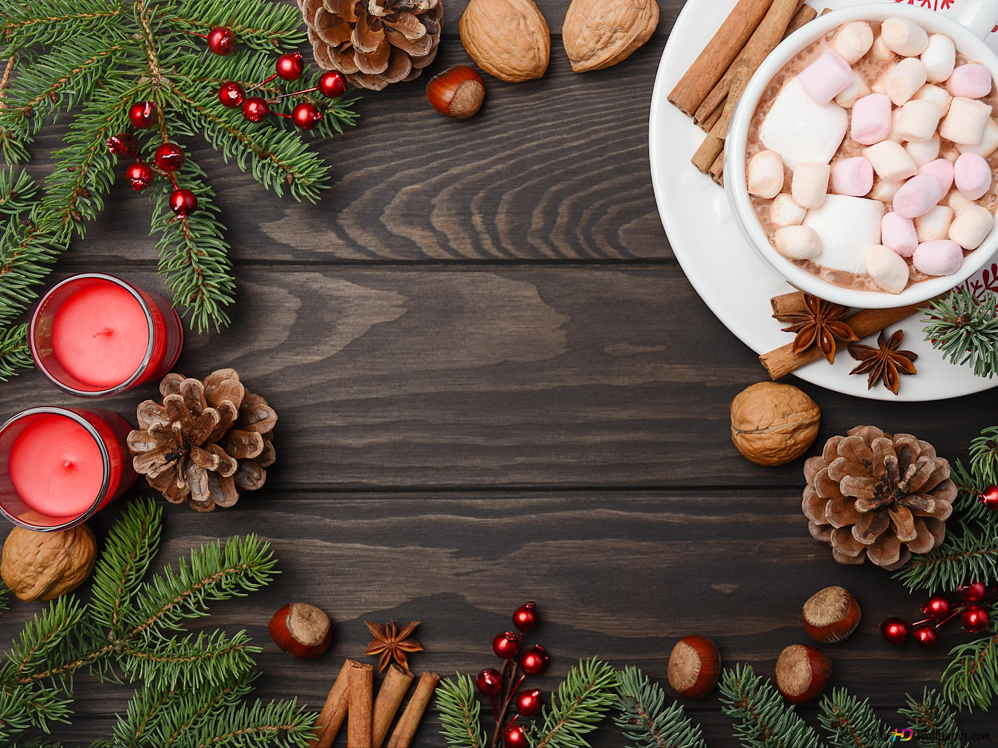A wooden table with christmas decorations and food - Marshmallows