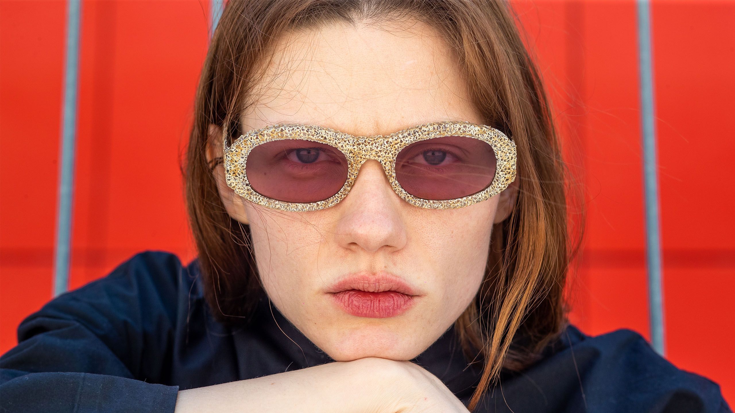 A woman wearing sunglasses and posing for the camera - 3D glasses