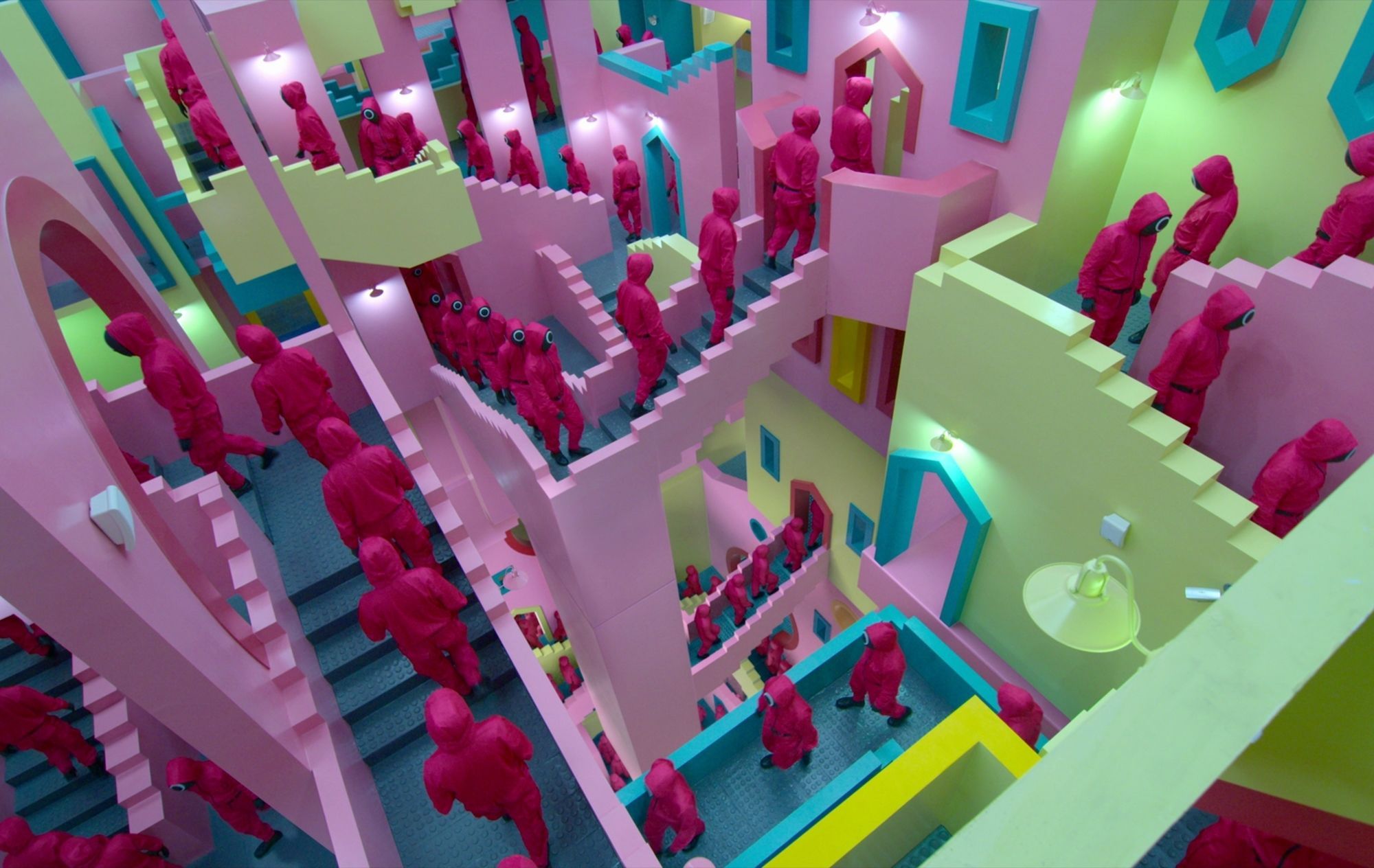 A pink crowd of people walking down a colorful staircase. - Squid Game