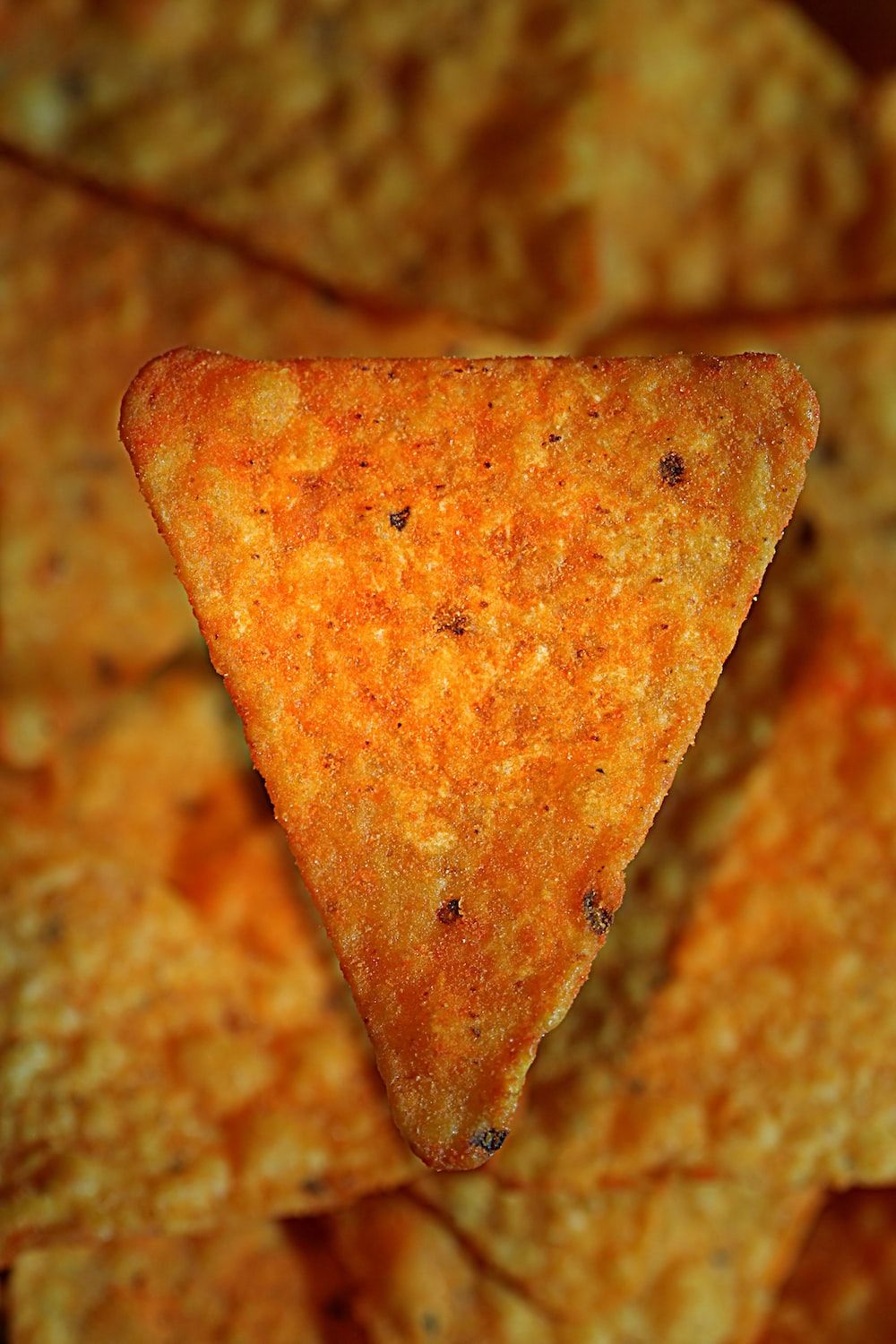 A close up of some tortilla chips - Doritos