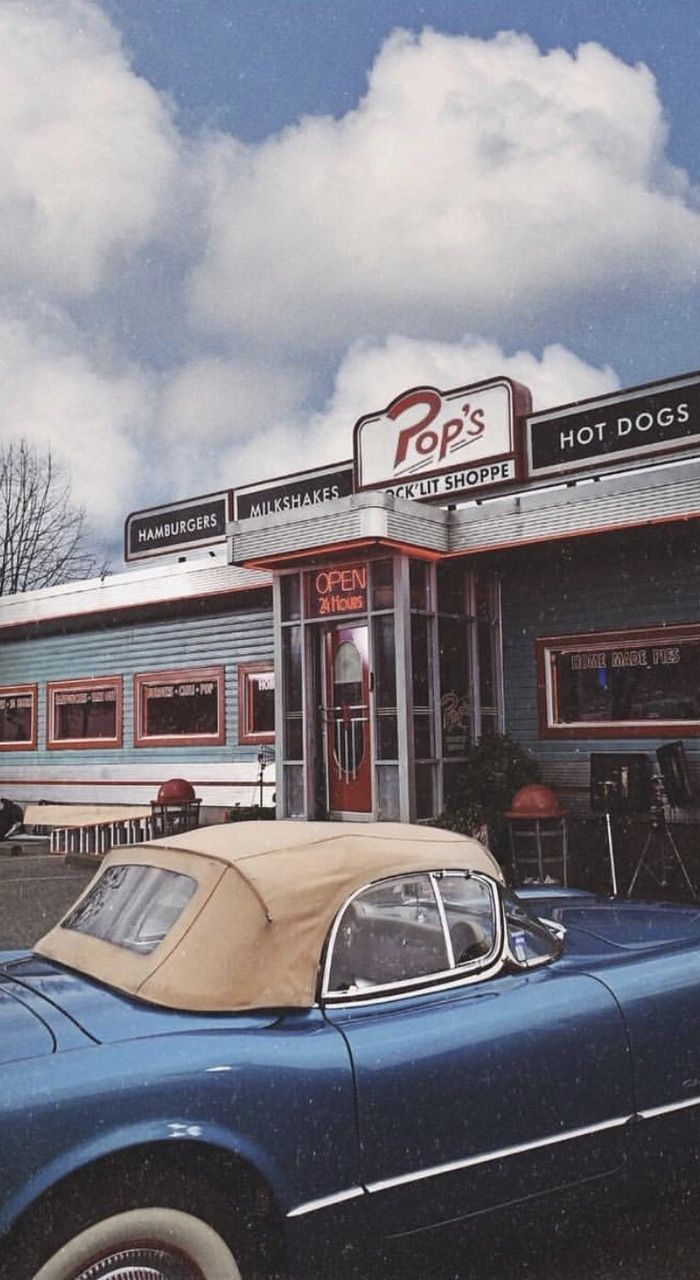 A blue vintage car parked in front of a diner. - Riverdale