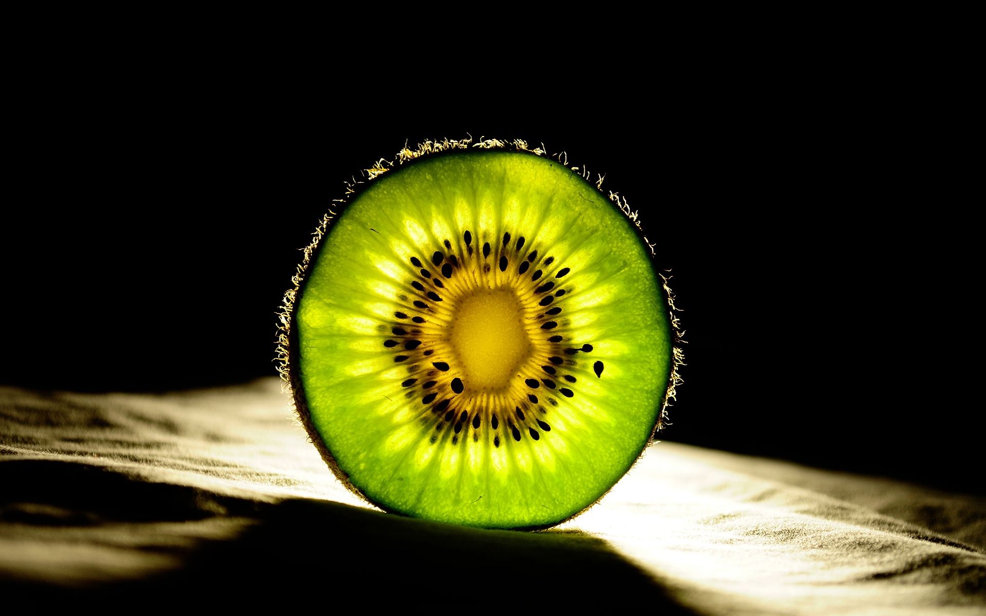 A kiwi fruit is cut in half - Kiwi