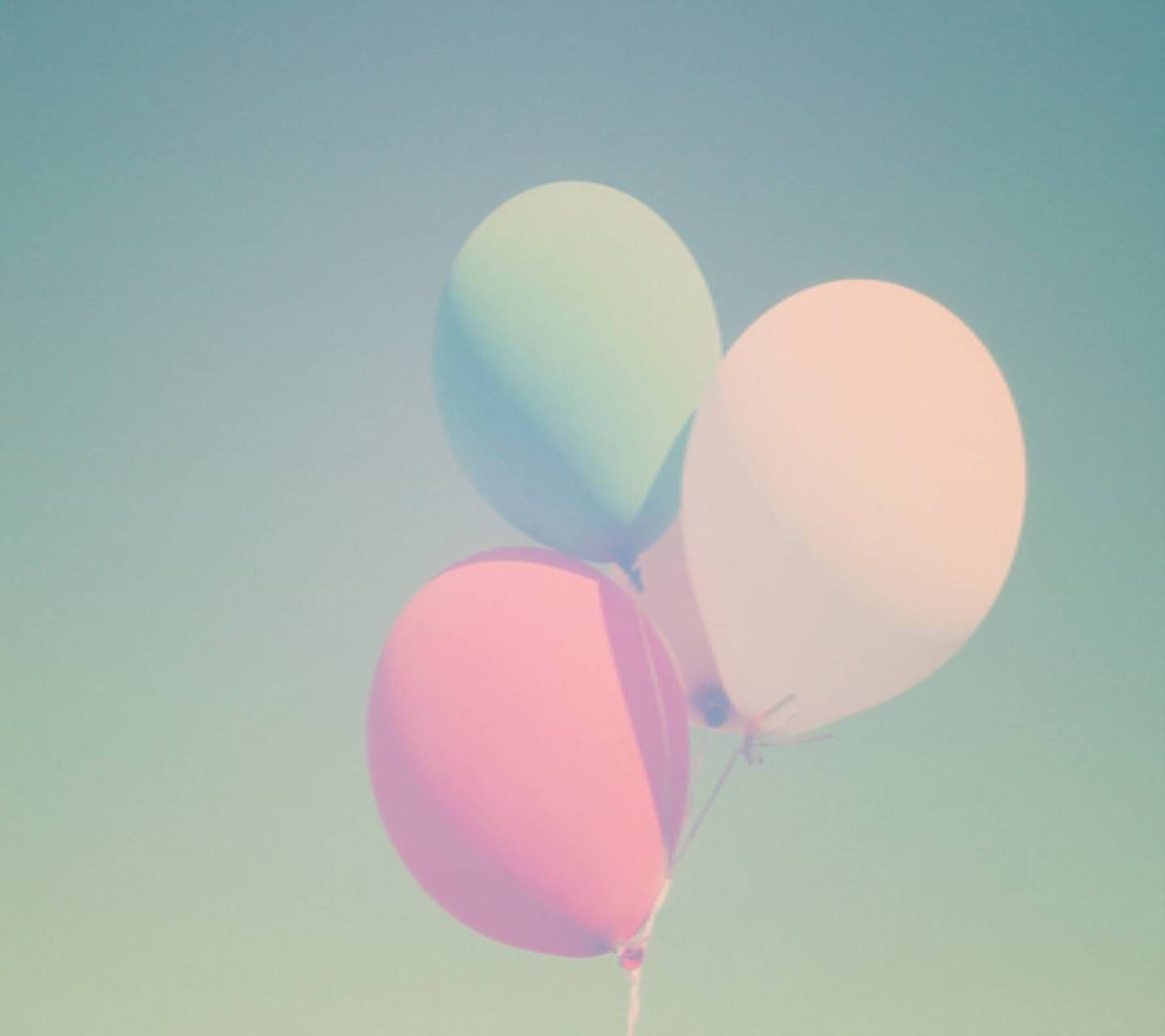 A couple of balloons are flying in the sky - Balloons