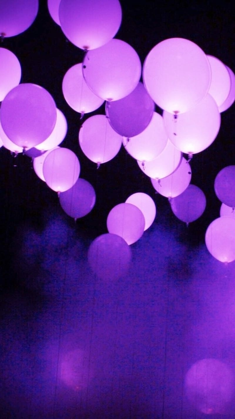 A group of purple balloons in the air - Balloons