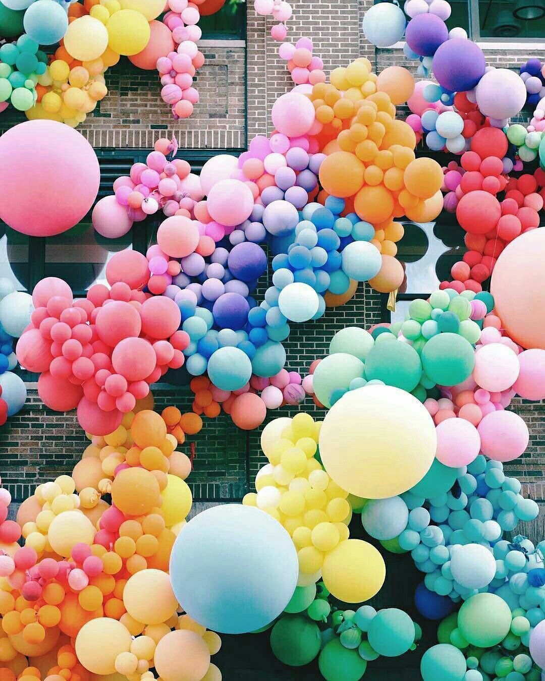 A colorful balloon wall with many different colors - Balloons