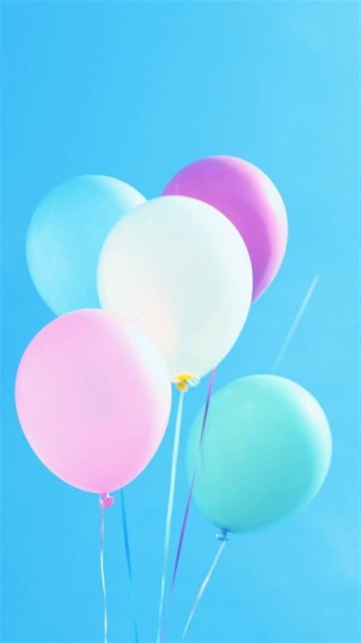 A group of balloons in different colors against the sky - Balloons