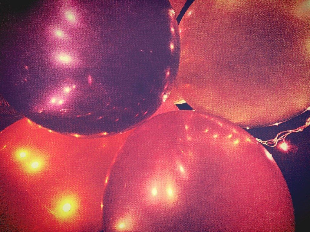 A string of red and pink balloons with fairy lights - Balloons