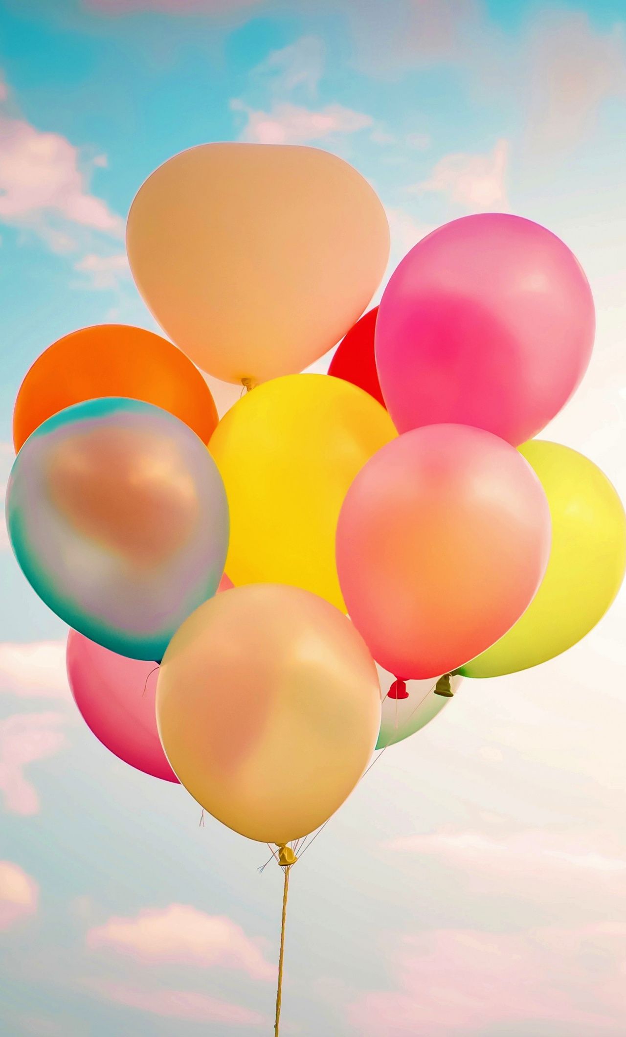 A bunch of colorful balloons floating in the air - Balloons