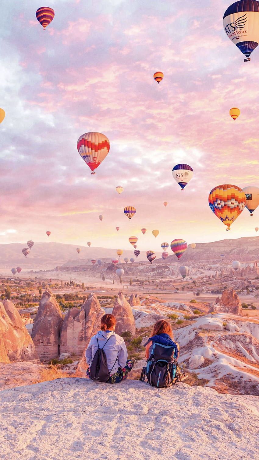 A couple of people sitting on top - Hot air balloons