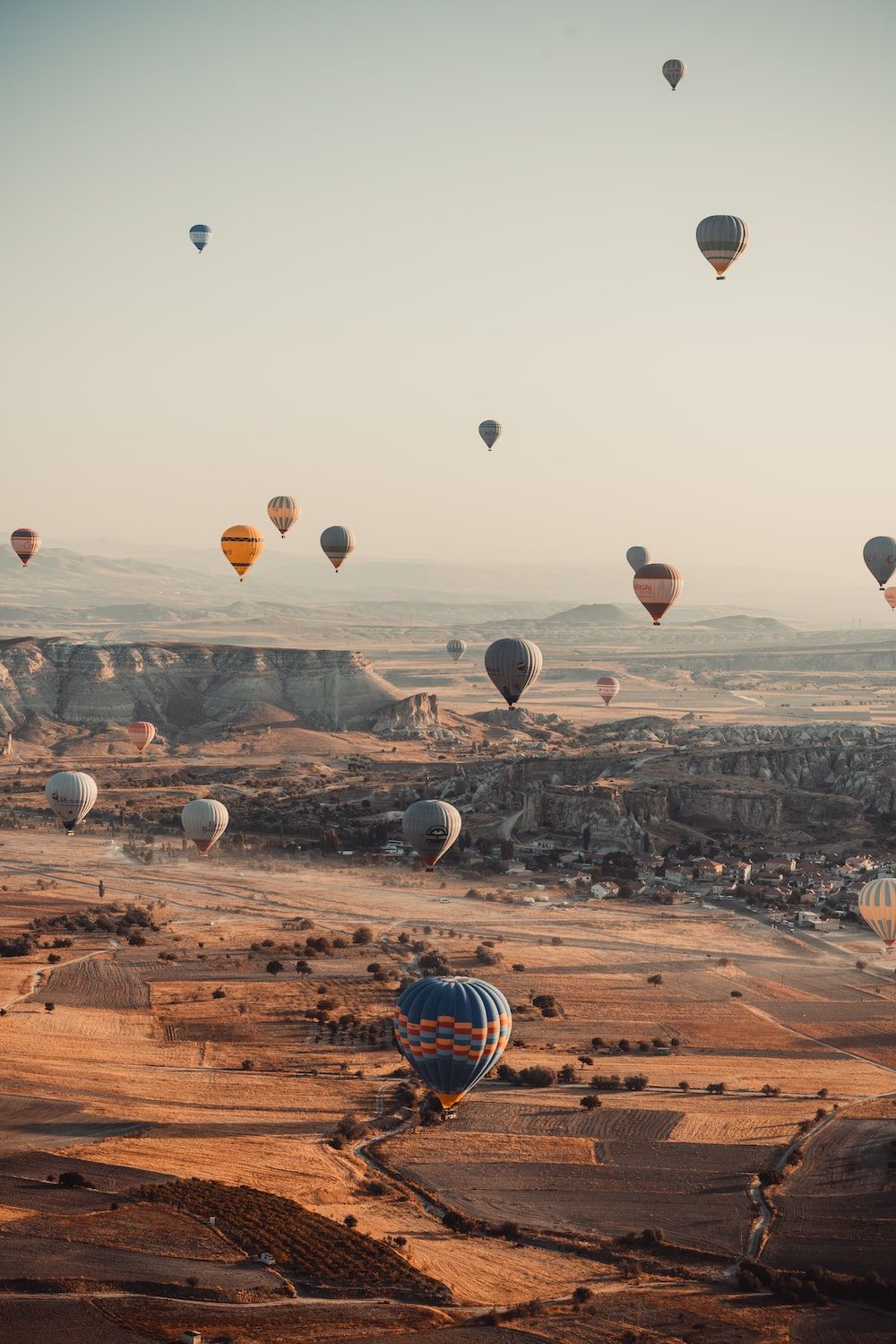 Hot air balloons flying over a valley - Hot air balloons