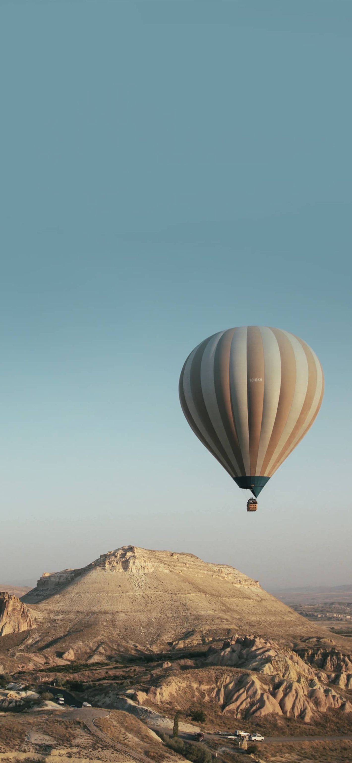 A hot air balloon flying over the desert - Hot air balloons