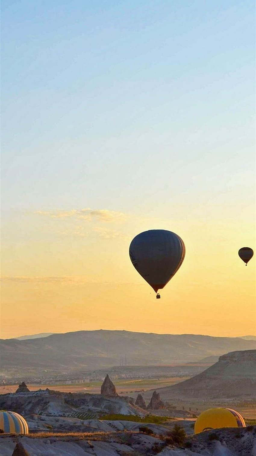 Hot air balloons flying over the mountains during sunset - Hot air balloons