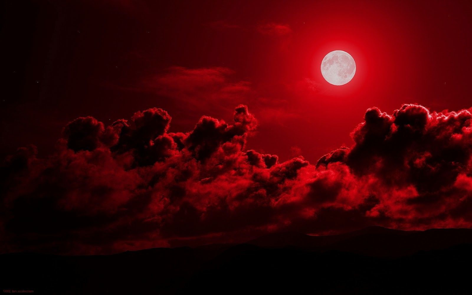 A red moon is shown in the sky - Eclipse