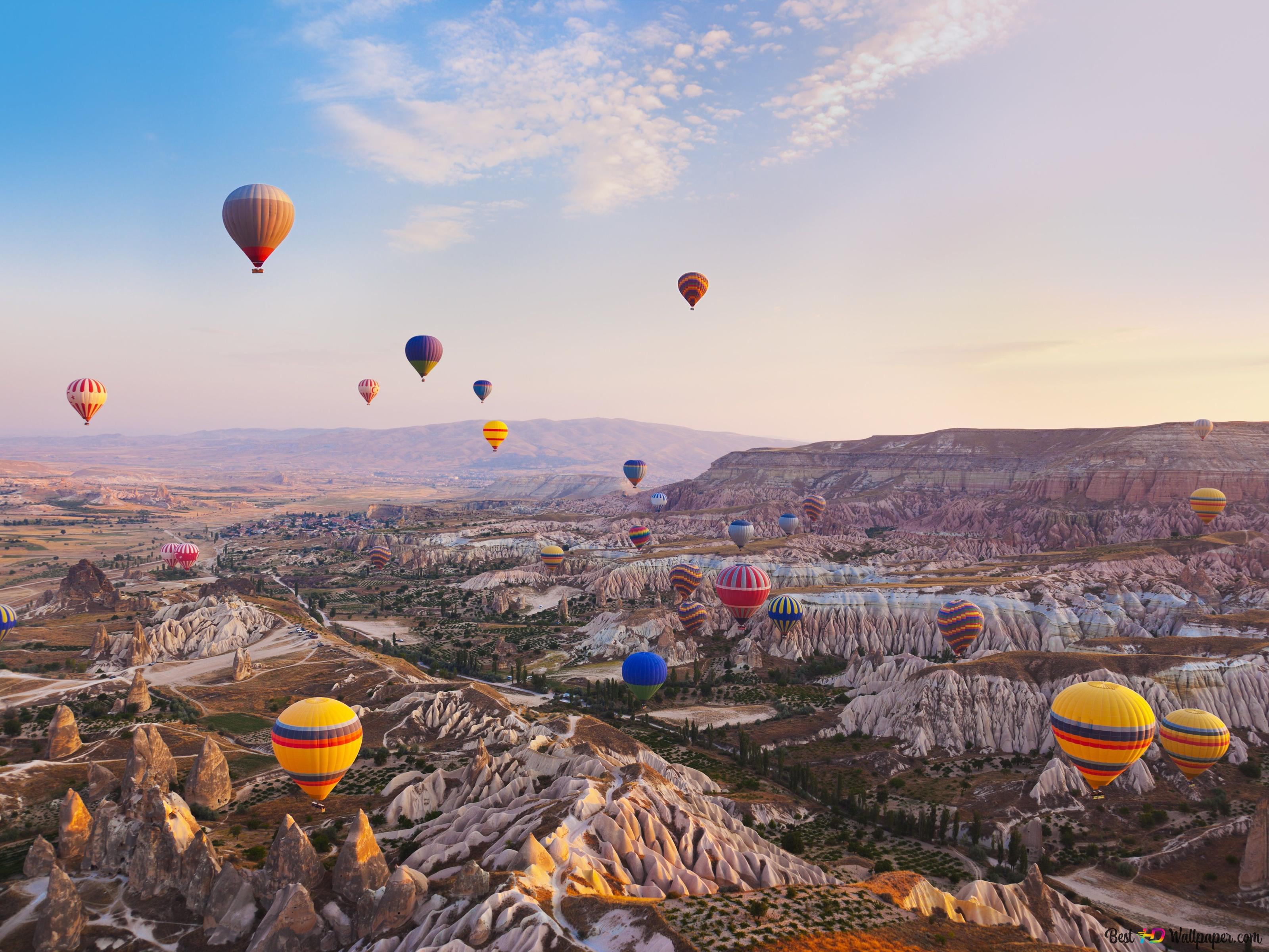 Hot air balloons flying over a rocky landscape - Hot air balloons