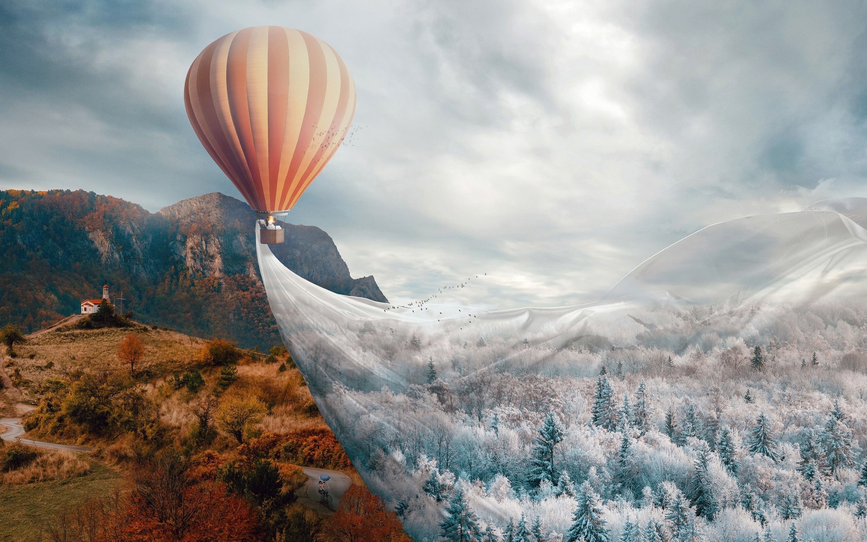 A hot air balloon flying over a snowy landscape - Hot air balloons