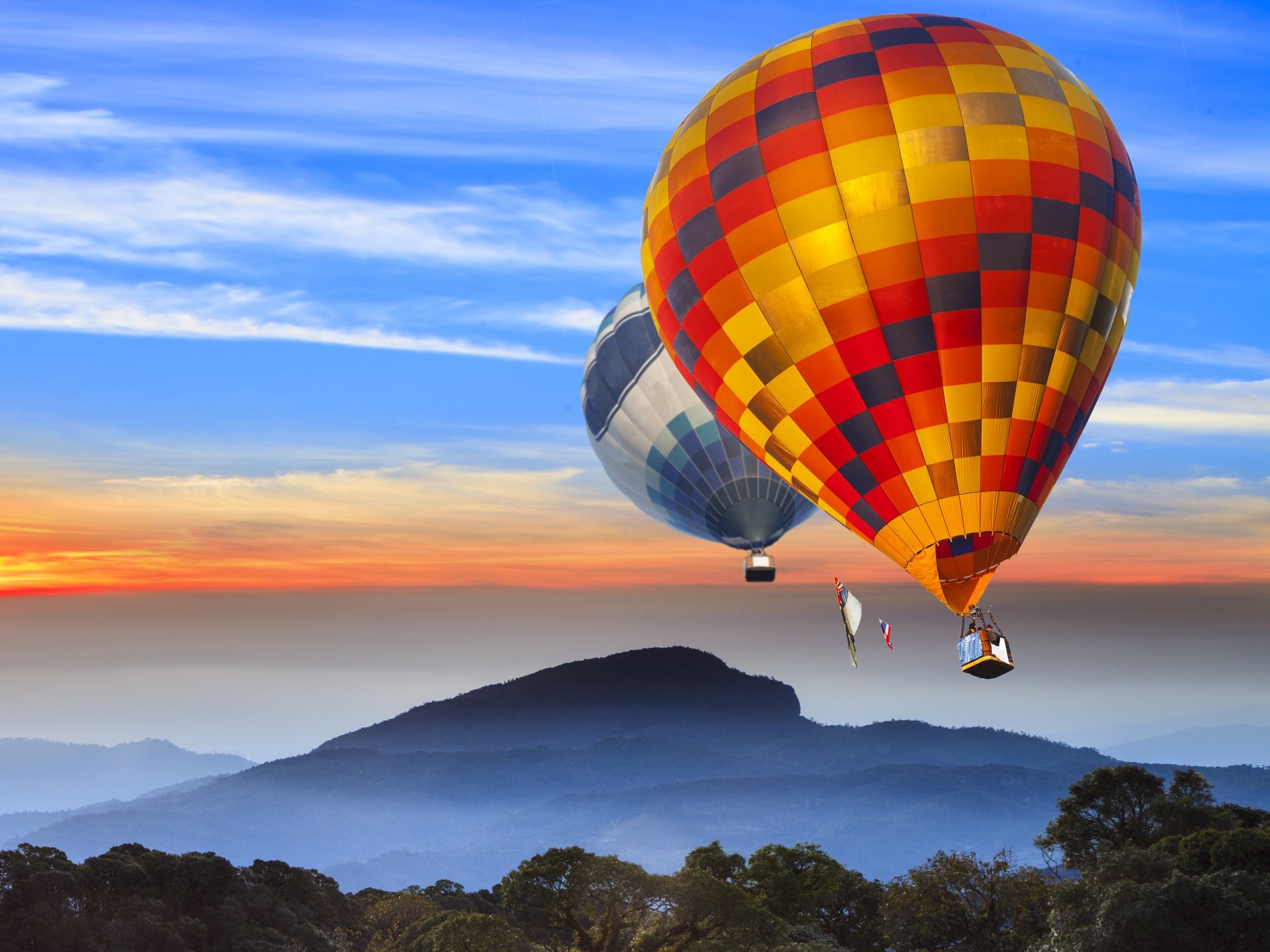 A couple of hot air balloons flying in the sky - Hot air balloons