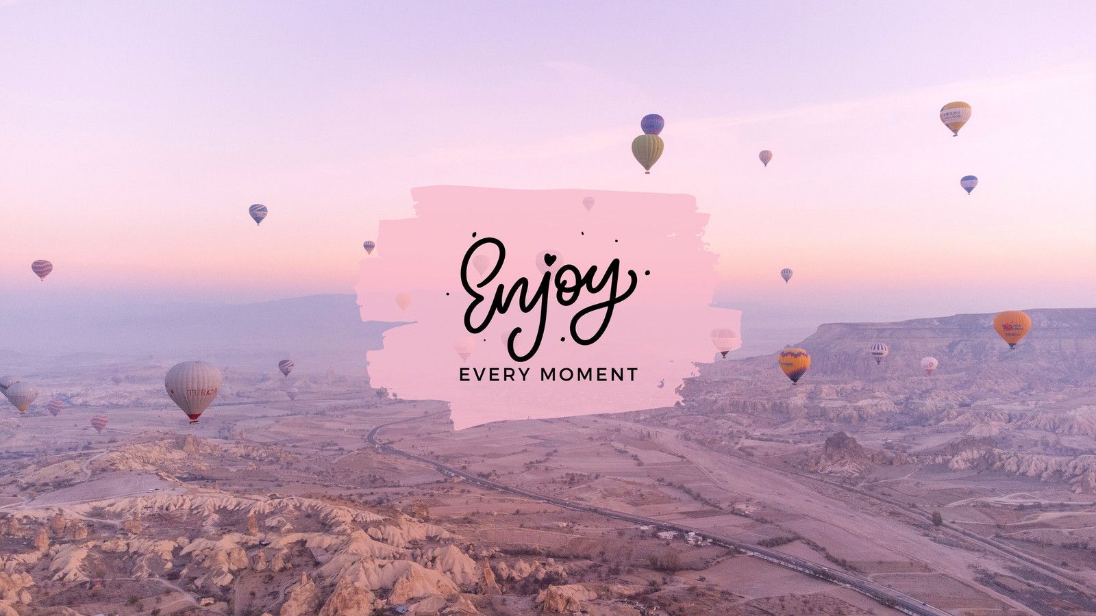 Hot air balloons flying over a valley with the words 