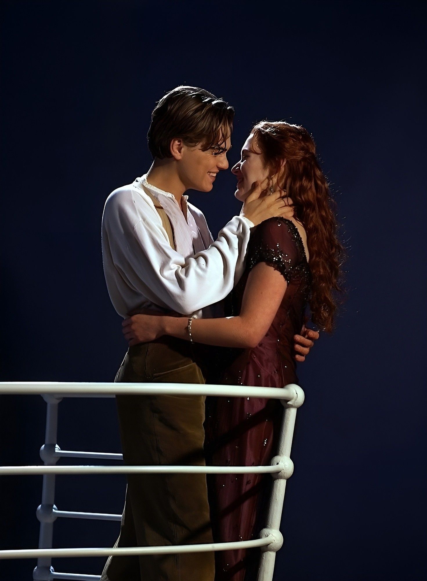 A man and woman are standing on the deck of ship - Leonardo DiCaprio