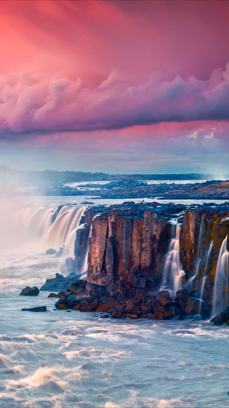 A beautiful waterfall surrounded by rocks - Waterfall