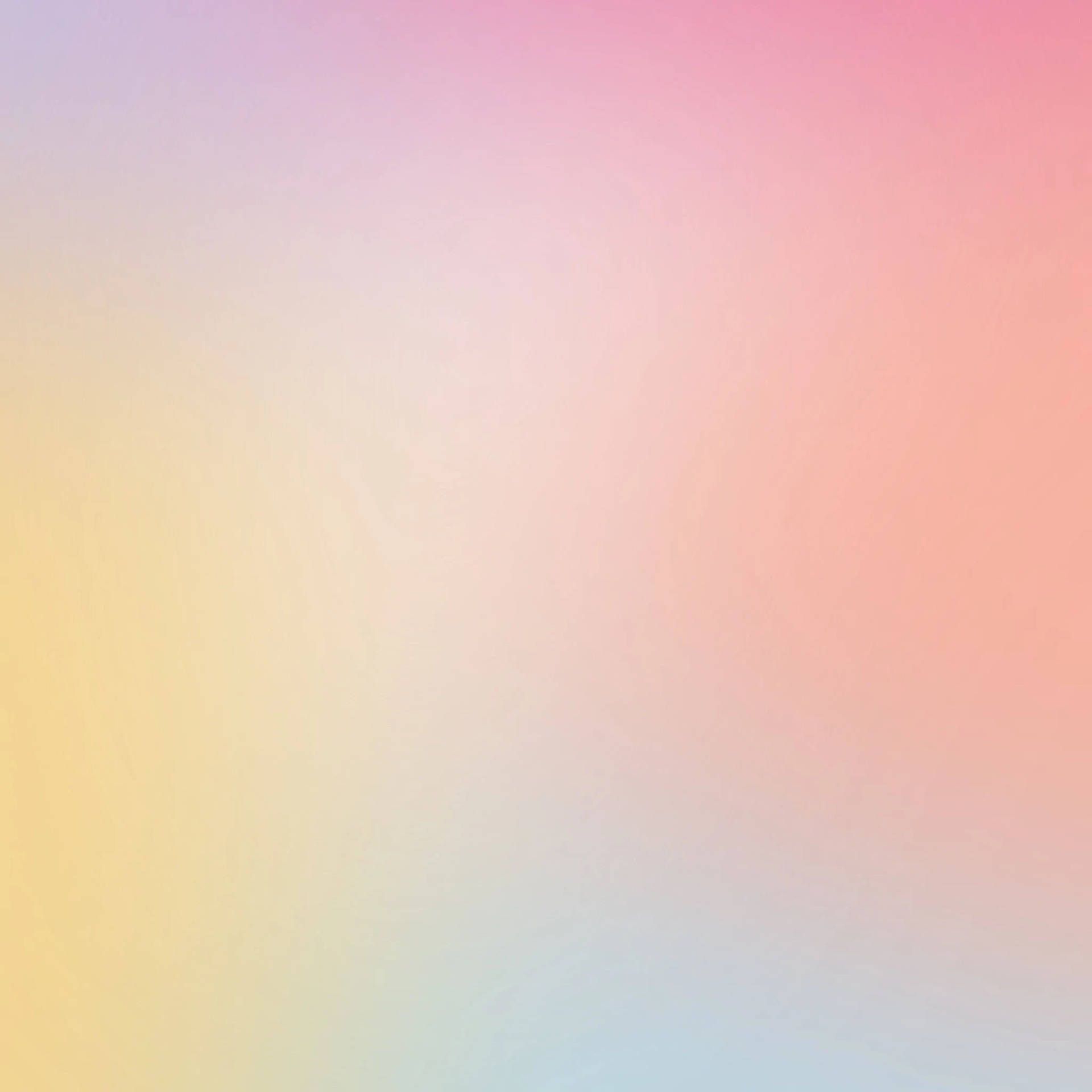 A soft, pastel colored wallpaper with a gradient of yellow, pink, and blue. - Gradient