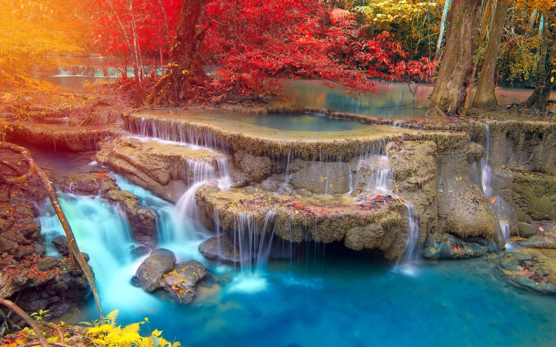 A waterfall surrounded by trees in the fall. - Waterfall