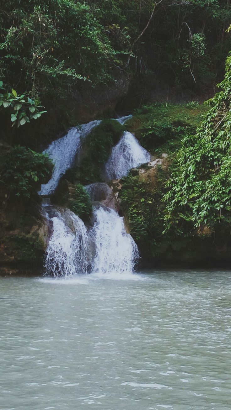 A man is standing in the water - Waterfall