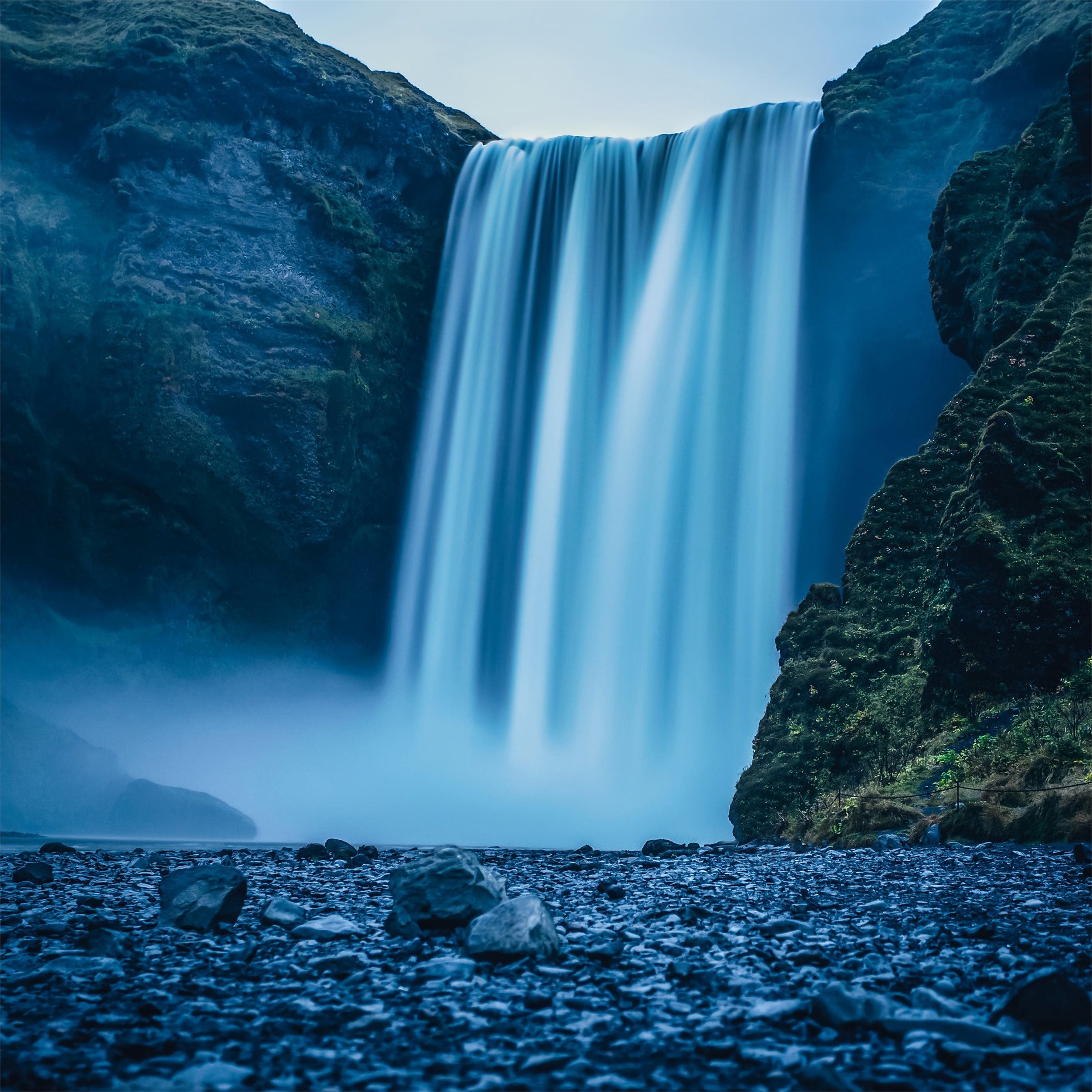 A waterfall is flowing down into the rocks - Waterfall