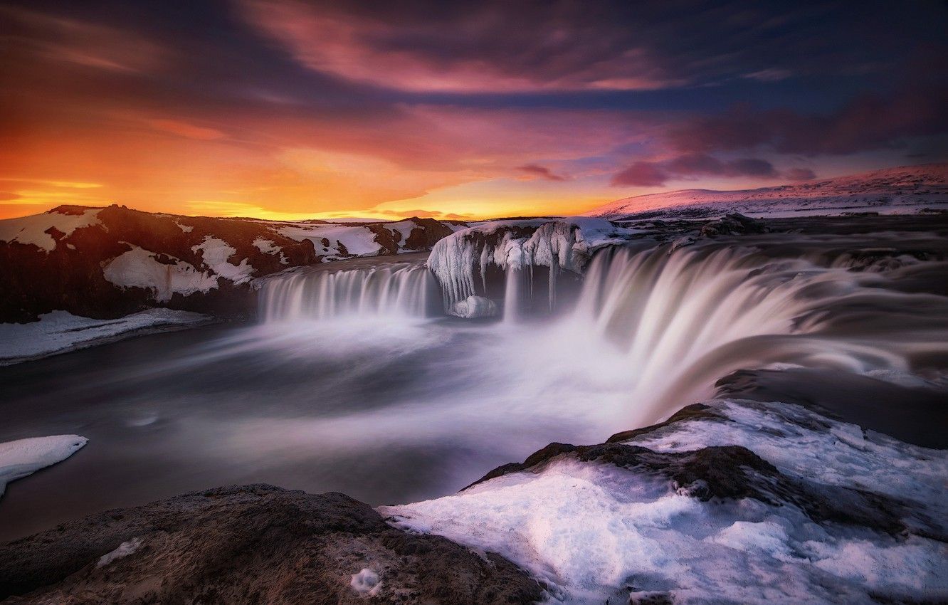 A waterfall in the snow with sunset - Waterfall