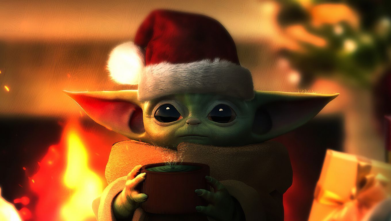 Baby Yoda in a Santa hat holding a cup of hot chocolate in front of a fireplace. - Baby Yoda