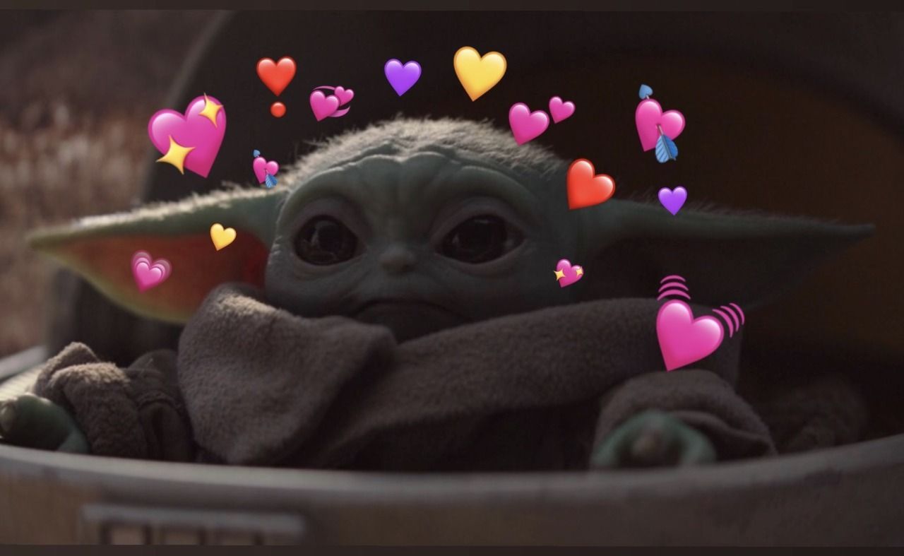 A baby yoda in a tin with hearts around it - Baby Yoda